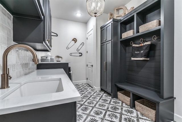 interior space with cabinets, sink, and a chandelier