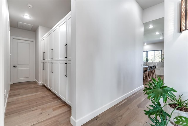 hallway with light hardwood / wood-style flooring