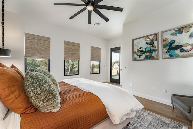 bedroom featuring wood-type flooring, access to outside, and ceiling fan