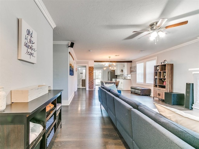 living room featuring a textured ceiling, dark hardwood / wood-style floors, ornamental molding, and ceiling fan with notable chandelier