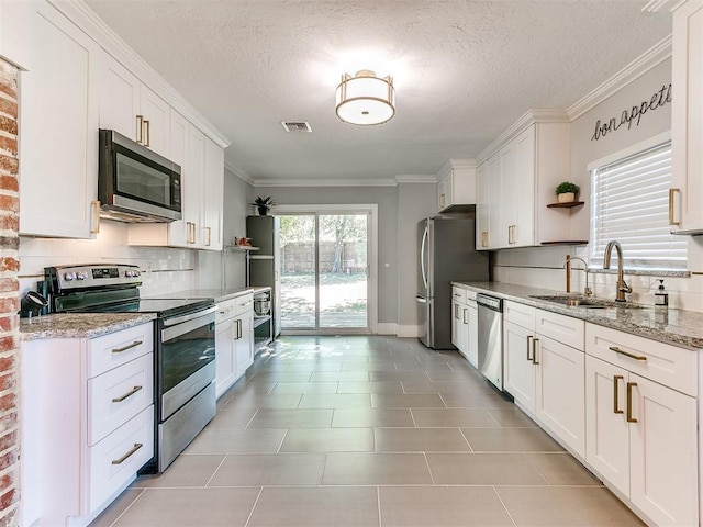 kitchen featuring white cabinets, a textured ceiling, and appliances with stainless steel finishes