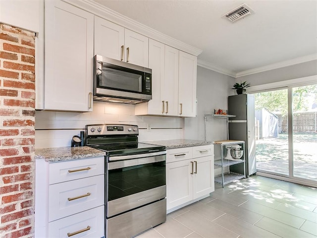 kitchen with backsplash, light stone countertops, ornamental molding, white cabinetry, and stainless steel appliances