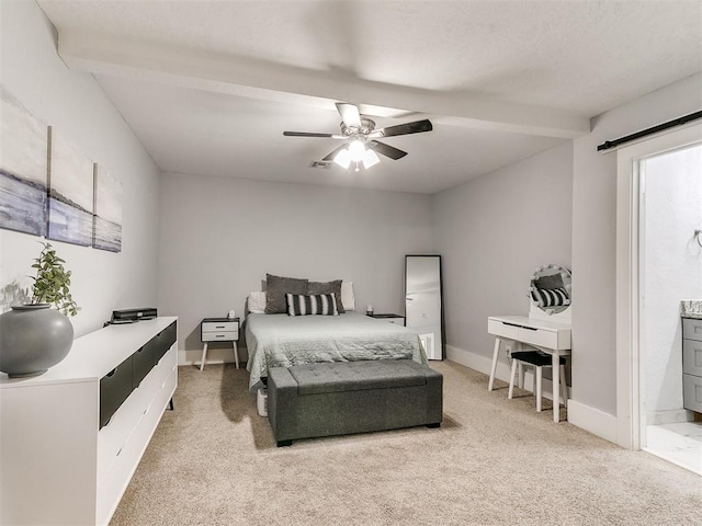 bedroom with carpet, ceiling fan, beam ceiling, and ensuite bath