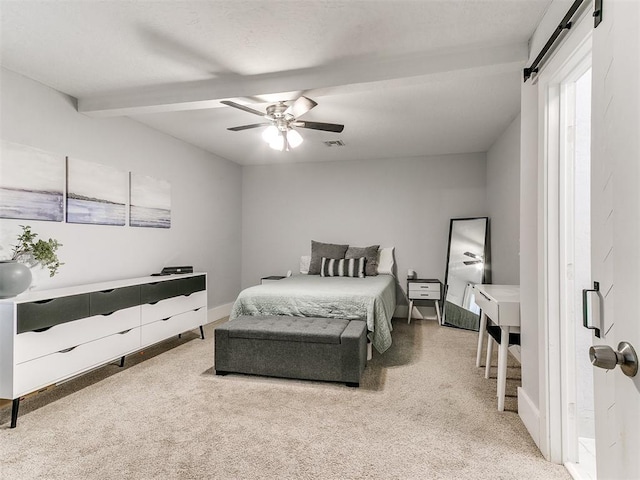 bedroom featuring carpet, a barn door, ceiling fan, and beamed ceiling