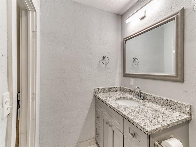 bathroom featuring vanity and a textured ceiling