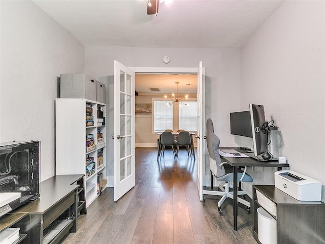 office space featuring a notable chandelier, dark hardwood / wood-style floors, and french doors