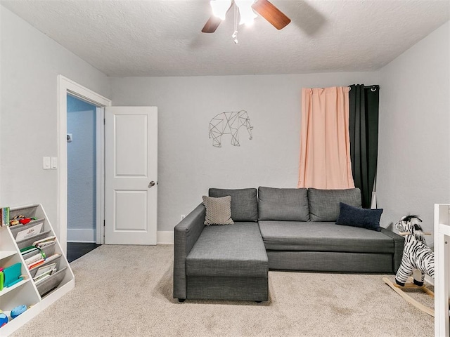 carpeted living room with a textured ceiling and ceiling fan