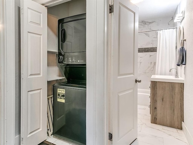 washroom with sink and stacked washer and dryer