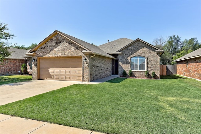 view of front of home featuring a garage and a front yard