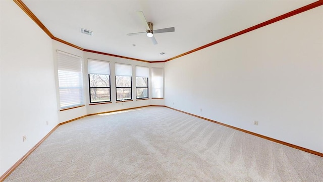 unfurnished room with light carpet, ceiling fan, and crown molding