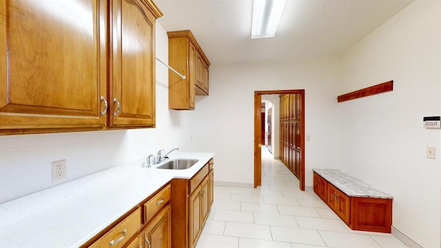 kitchen featuring sink and light tile patterned floors