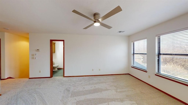 carpeted spare room with ceiling fan