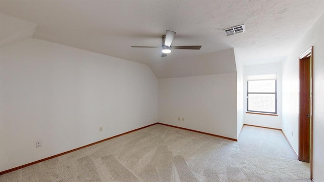 bonus room with light carpet, ceiling fan, and lofted ceiling