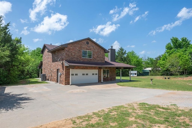 view of front of property featuring a front lawn, a garage, and cooling unit