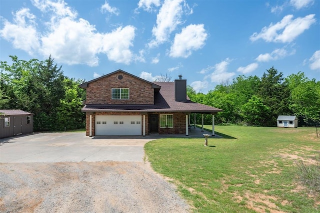 view of front of property with a front lawn, a storage unit, and a garage