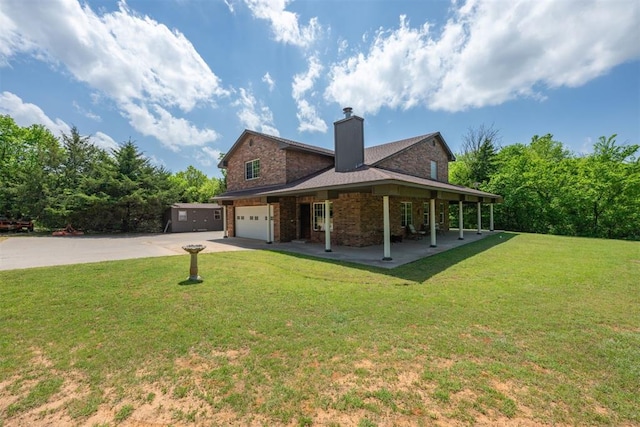 back of house with a porch, a yard, and a garage