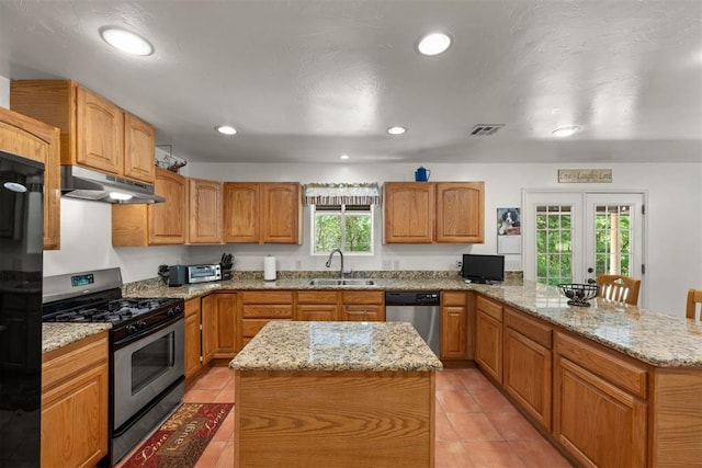 kitchen with sink, a center island, french doors, and appliances with stainless steel finishes