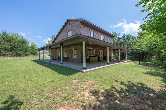 rear view of property featuring a yard and a patio area