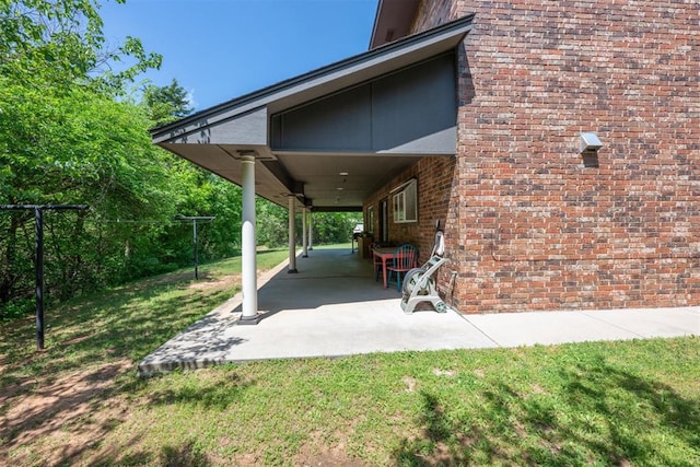 exterior space with a lawn and a patio