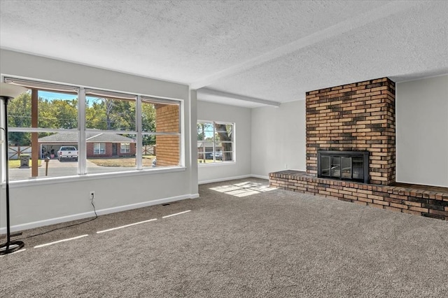 unfurnished living room with carpet flooring, a fireplace, and a textured ceiling