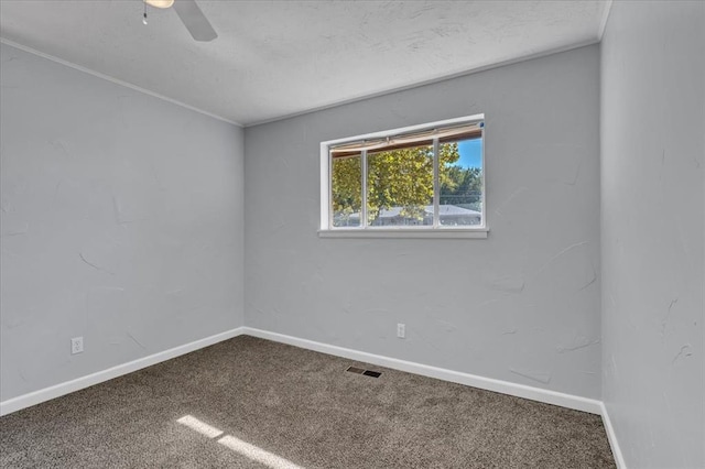 spare room featuring carpet flooring and ceiling fan