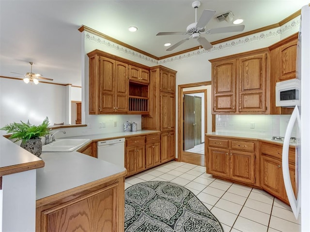 kitchen featuring visible vents, a sink, white appliances, light tile patterned flooring, and light countertops