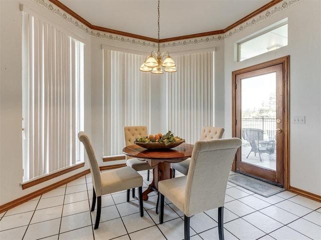 dining room featuring crown molding, light tile patterned floors, baseboards, and a chandelier