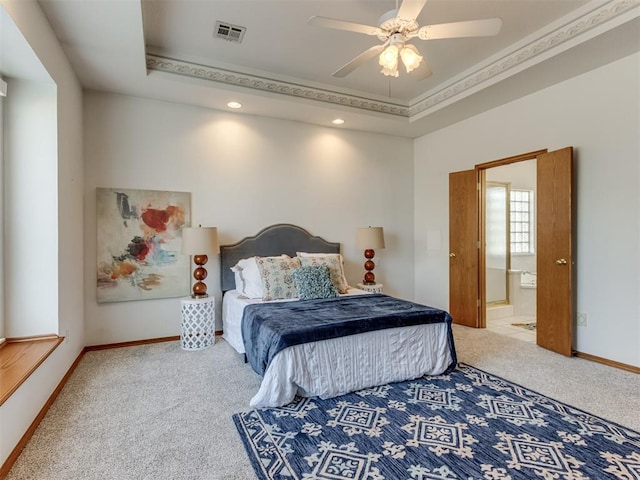 carpeted bedroom with a raised ceiling, baseboards, and visible vents