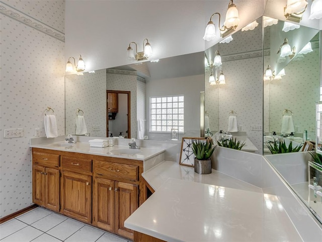 bathroom with tile patterned floors, double vanity, wallpapered walls, and a sink