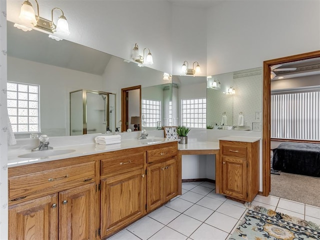 full bath featuring tile patterned flooring, a shower stall, double vanity, and a sink