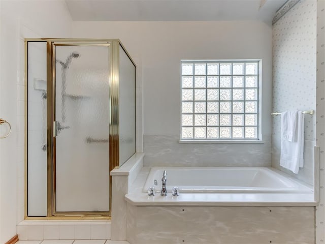 full bath featuring a bath and a shower stall