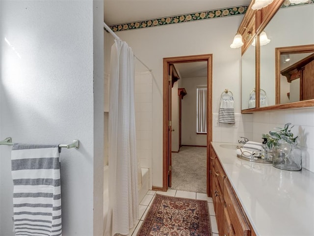 full bath with tile patterned floors, decorative backsplash, vanity, and shower / tub combo