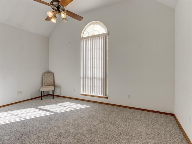 carpeted empty room with baseboards, lofted ceiling, and ceiling fan