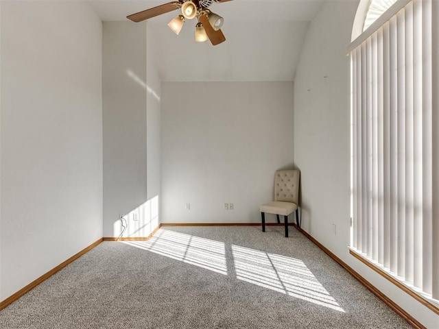 spare room featuring lofted ceiling, a ceiling fan, baseboards, and carpet floors