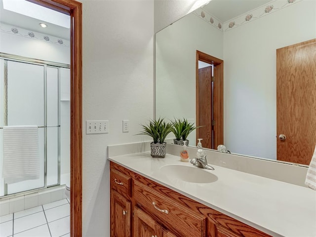 bathroom featuring vanity, tile patterned floors, and a stall shower