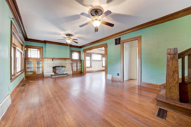 unfurnished living room with light hardwood / wood-style flooring, ceiling fan, and crown molding