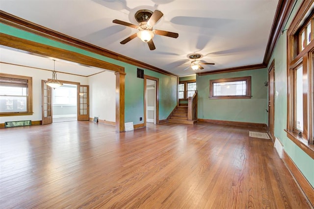 unfurnished room featuring light hardwood / wood-style flooring, a wealth of natural light, ornamental molding, and ceiling fan