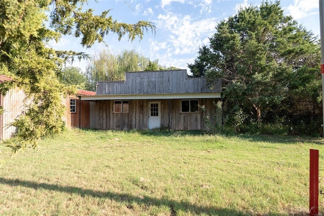 view of outbuilding featuring a lawn