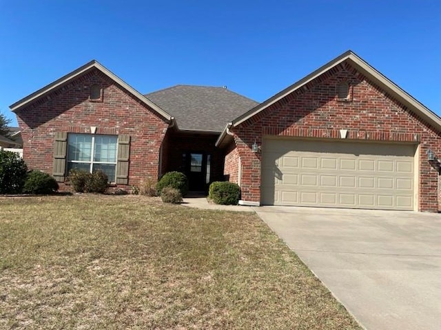 view of front property featuring a garage and a front lawn