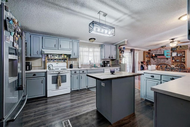 kitchen featuring under cabinet range hood, dark wood-type flooring, white electric range, and stainless steel refrigerator with ice dispenser