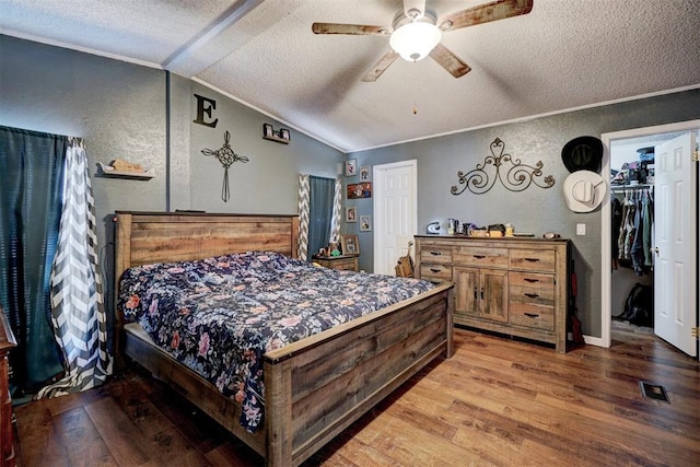 bedroom featuring wood finished floors, ornamental molding, and vaulted ceiling