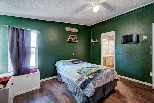 bedroom with wood finished floors, baseboards, a textured wall, and a textured ceiling