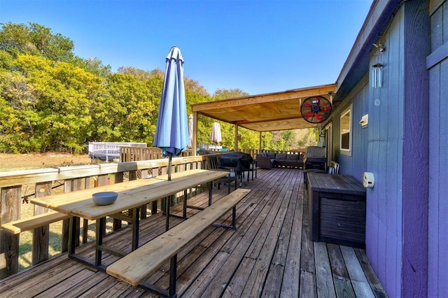 wooden terrace with outdoor dining area