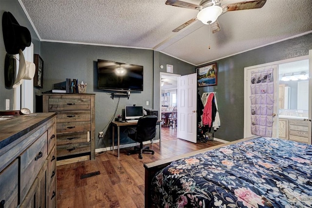 bedroom featuring a textured ceiling, crown molding, lofted ceiling, and wood finished floors