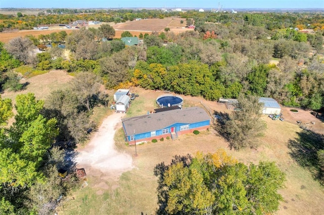 drone / aerial view featuring a view of trees