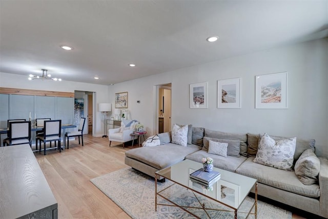 living room featuring light hardwood / wood-style flooring and a notable chandelier