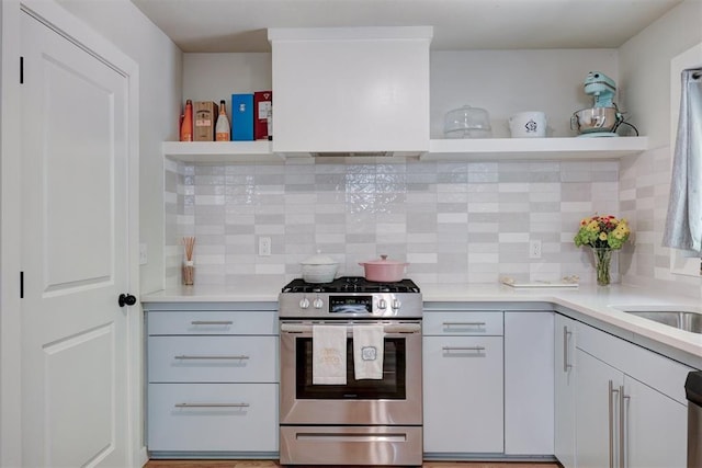 kitchen with white cabinetry, decorative backsplash, and stainless steel appliances