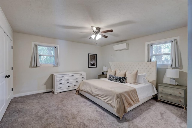 bedroom with ceiling fan, light colored carpet, and multiple windows