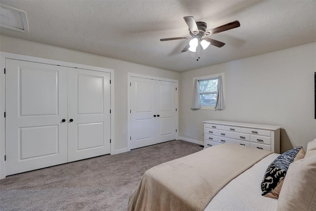 carpeted bedroom featuring a textured ceiling and ceiling fan