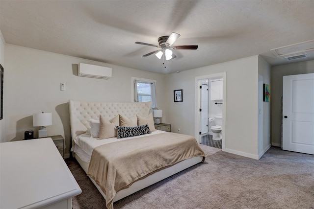 carpeted bedroom with a wall mounted air conditioner, ceiling fan, a textured ceiling, and ensuite bath